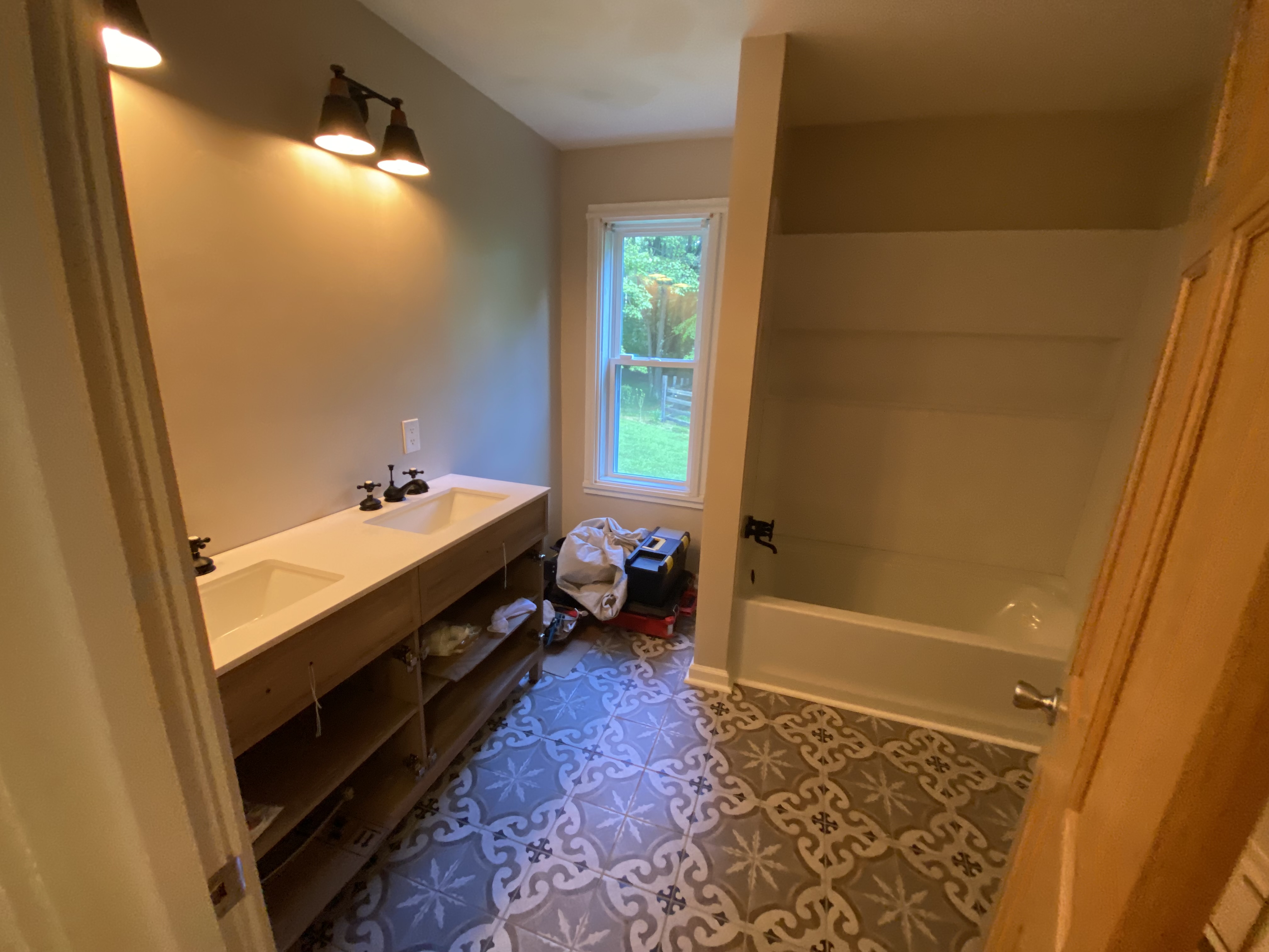 Bathroom remodel with double vanity and tile floor